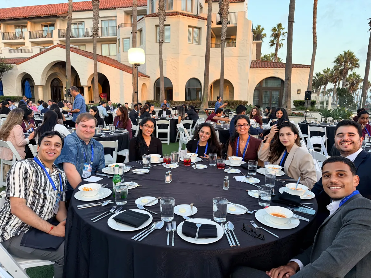 Guests smiling together at a banquet table.