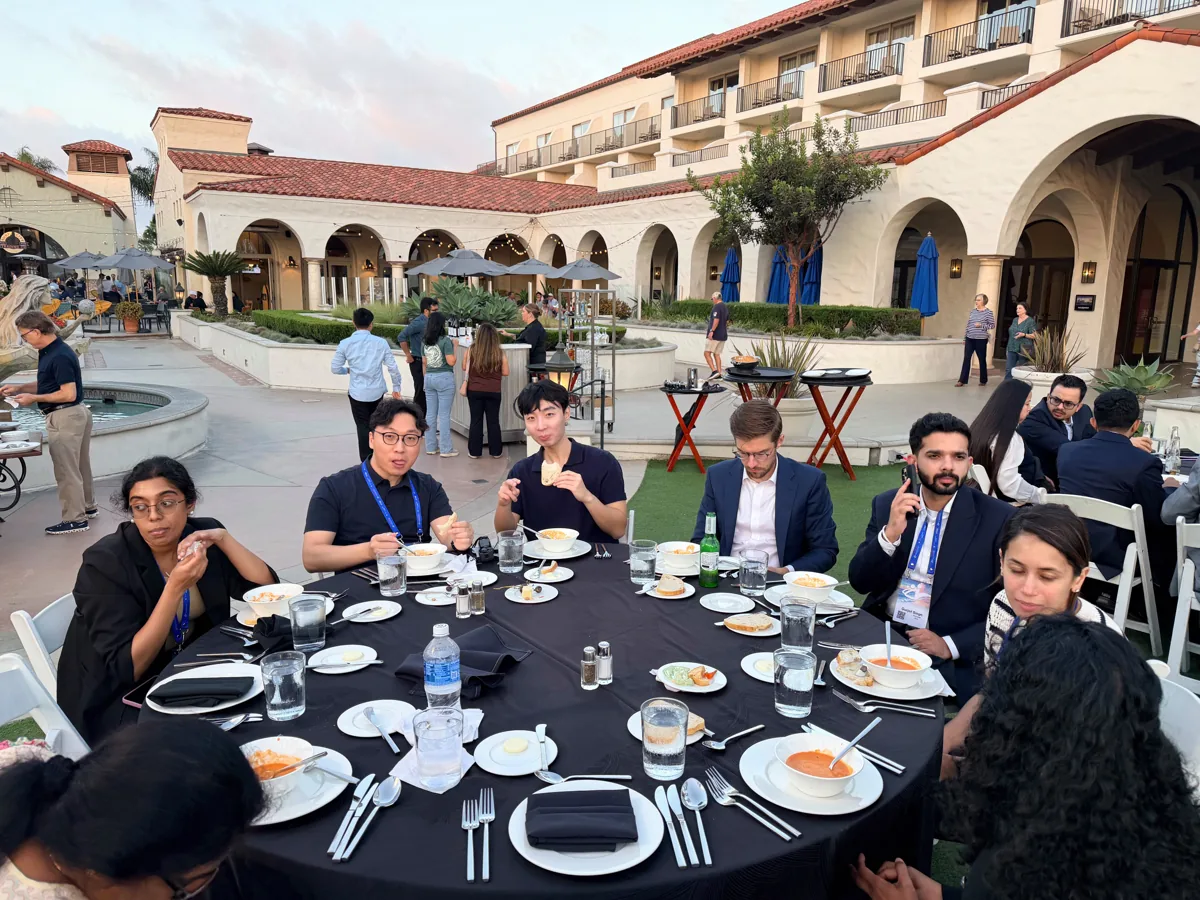 Colleagues seated together outside at the awards banquet.