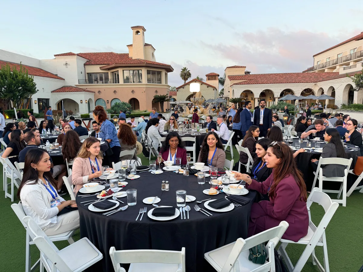 Guests in conversation around a banquet table.